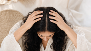 Woman parting her hair to check her scalp and hair density